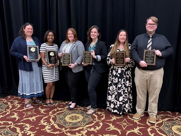 Sean Crampton, Jennifer Carter, Manda Sexton, Kristina Clement, Chelsee Dickson, Rosemary Humphrey holding GLA awards.